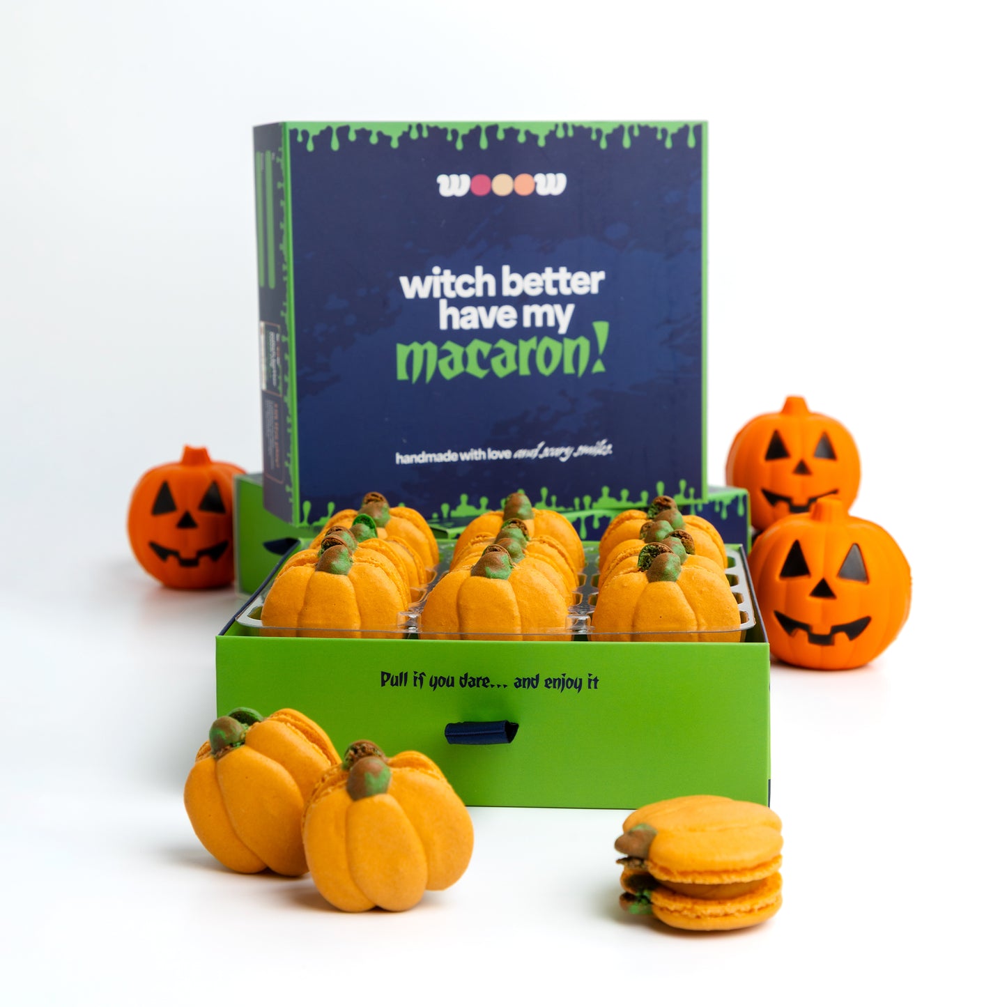 Pumpkin shaped Halloween macarons orange French macaron cookies in pumpkin spice flavor. Cute spooky fall treats in gift box for Halloween party or gift for him or her.